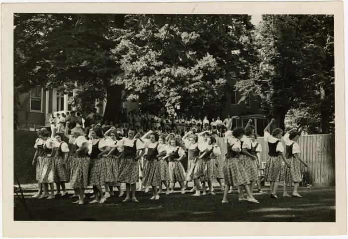 Costumed students dance 