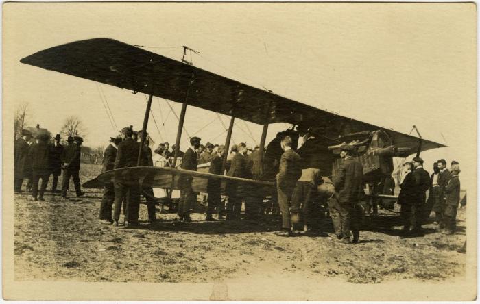 Biplane and crowd