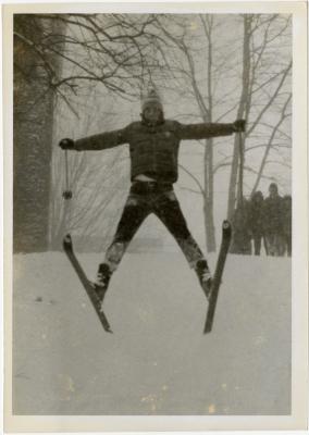 Student skiing in front of crowd
