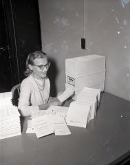 Woman with 175th Anniversary programs